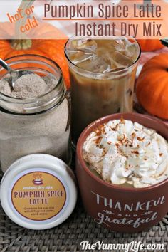 pumpkin spice latte with whipped cream in a mug and other ingredients on a table