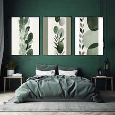 three paintings on the wall above a bed in a room with green walls and wooden flooring