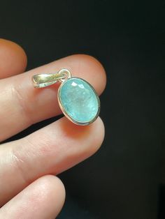 This beautiful little Aquamarine pendant is handmade with sterling silver and genuine Aquamarine. The stone is faceted and the color is natural. This little oval beauty measures 10mm wide by 25mm tall (including bail).  Aquamarine is associated with the throat chakra. It is a powerful healing crystal and can help one speak their truth, and find their voice. It's a lovely stone with a soothing energy. Faceted Gemstone Pendant Gift, Faceted Oval Sterling Silver Gemstones, Faceted Sterling Silver Gemstones As Gifts, Oval Faceted Sterling Silver Gemstone, Silver Oval Apatite Jewelry, Oval Faceted Gemstones For Gifts, Handmade Oval Apatite Jewelry, Aquamarine Pendant, Aquamarine Crystal