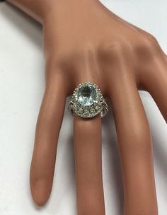 5.85 Carats Natural Aquamarine and Diamond 14K Solid White Gold Ring Suggested Replacement Value: $9,200.00 Total Natural Oval Cut Aquamarine Weights: 3.60 Carats Aquamarine Measures: 11.44 x 8.71mm Natural Round Diamonds Weight: 2.25 Carats (color G / Clarity VS2-SI1) Ring total weight: 6.9 grams Disclaimer: all weights, measurements and colors are approximate and may vary slightly from the listed dimensions or as seen in the image. All pictures are magnified to show the smallest of details. Pl Emerald Cut Aquamarine Ring, Emerald Cut Rings, Etsy Gold Ring, Natural Tanzanite, Aquamarine Rings, Blue Band, Ring Photos, White Gold Ring, Natural Aquamarine