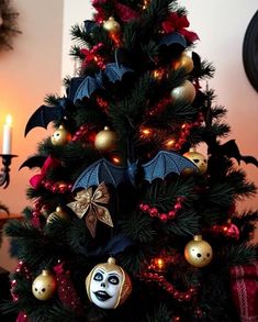 a decorated christmas tree with decorations and lights in the shape of bats, balls and ornaments