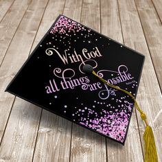 a black graduation cap with pink and purple confetti on it that says, with god all things are possible