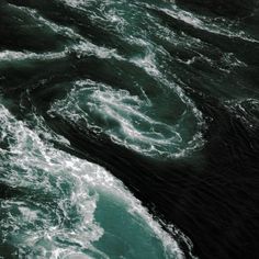 an aerial view of the ocean with waves