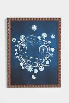 a blue painting with white flowers on it