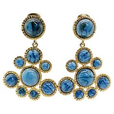 An outstanding pair of vintage KJL Sapphire earrings oozing glamour and style. Featuring a wonderfully designed crimped gold mount of statement proportion. Set to perfection with exquisite stones - large cabochon sapphire blue with a 'flawed' gemstone effect cleverly created within the glass. Join the long line of illustrious names who've worn Lane's jewellery since the 1960s adding the ultimate accessory to your look. Vintage Condition: Very good without damage or noteworthy wear. Materials: Go Vintage Yellow Gold Clip-on Earrings For Party, Gold Mid-century Clip-on Earrings For Party, Mid-century Gold Clip-on Earrings For Party, Mid-century Clip-on Earrings For Party, Rose Gold Jewellery, Antiques And Collectibles, Rose Gold Jewelry, Sapphire Earrings, Vintage Jewels