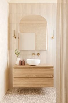 a bathroom with a sink and mirror in it