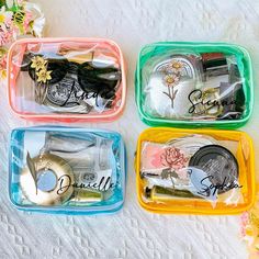 four plastic trays filled with assorted items on top of a white tablecloth