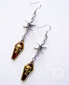 made from stained alloy metal with a size of 3 inches long and 2 cm in with. Nickel-free Metal Alternative Style Earrings, Vampire Style Metal Pierced Earrings, Alternative Style Nickel-free Metal Earrings, Nickel-free Metal Earrings In Alternative Style, Edgy Metal Earrings With Ear Wire, Edgy Adjustable Earrings For Halloween, Edgy Halloween Jewelry, Nickel-free Metal Grunge Earrings, Nickel-free Metal Earrings In Grunge Style