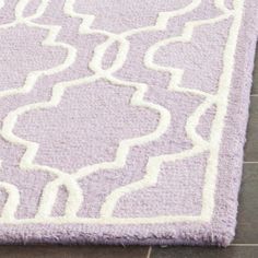 a purple and white rug on the floor