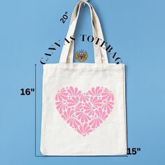 a tote bag with a pink heart on it and measurements for the size in front