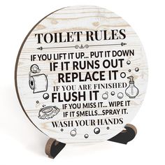 a wooden sign that says, toilet rules if you lift up put it down if it runs out replace it flush it