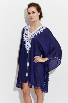 Majorelle Kaftan is made from the finest Egyptian cotton and decorated with navy blue embroidery and tassels. Perfect for wearing over a swimsuit with effortless elegance. 100% Cotton One Size Dry Clean Handmade in Morocco MAISON DU CAFTAN Embroidered Beachwear Cover-up For Beach Season, Blue Tassel Cover-up For Summer, Embroidered V-neck Beachwear Cover-up, Elegant Embroidered Kaftan For Vacation, Embroidered Swimwear For Beach In Summer, Embroidered Swimwear For Summer Beach, Embroidered Swimwear For Beach Vacation, Floral Embroidered Swimwear For Summer Beach, Summer Floral Embroidered Swimwear For Beach