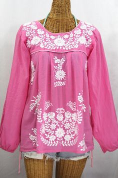 "The \"La Mariposa Larga\" Long Sleeve Mexican Blouse by Siren: * Ornate hand embroidery and elegant long sleeves with puff cuffs, available here in BUBBLEGUM PINK with WHITE embroidery. * Light, gauzy and semi-sheer 100% cotton throughout; wear it billowy and flowing in the traditional bohemian style. * Entirely hand dyed, distressed and embroidered for an authentic, retro-vintage and hippie casual vibe. * Our ornate butterfly floral embroidery patterns are a faithful tribute to the original Me Mexican Peasant Blouse, Embroidery Light, Hippie Blouse, Mexican Blouse, Floral Embroidery Patterns, Muslin Fabric, Mexican Style, White Embroidery, Peasant Blouse