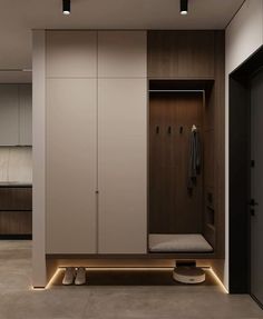 an empty walk in closet with lights on the floor