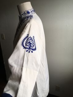 "1970s handmade embroidered tunic dress shirt cream with dark blue 3 button up neck side panels side slits (4 1/2\") nubby cotton w/light flecks light wear, good condition irregularities to fabric normal to artisan textiles no tags measures, flat, shoulder-14\" chest-20 sleeve-17 length-32" Summer Cotton Kurta With Embroidered Sleeves, Traditional White Kurta With Buttons, Cream Bohemian Cotton Kurta, Traditional Long Sleeve Tunic With Embroidered Sleeves, Cotton Peasant Tunic With Long Sleeves, Fitted Cotton Folk Kurta, Traditional Cotton Kurta For Fall, Folk Style Cotton Tunic Kurta, Folk Style Cotton Kurta For Festival