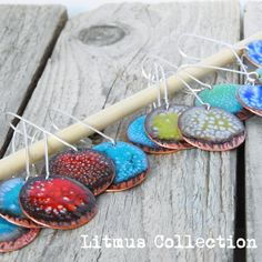 a group of colorful glass hearts hanging from clothes pins on a wooden board with text overlay that says, ultimate collection