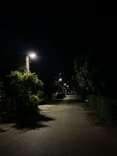 an empty street at night with no cars on it