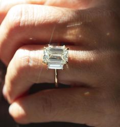 5.94 TC Elongated Emerald Cut Trilogy-14k Solid Yellow Gold-Baguette Cut Sides-Engagement Ring-Three Stone Ring-In Fashion-Celeb Style Ring ❤ ITEM DETAILS:- ✦ Brand: The American Gold House (TAGH) ✦ Handmade, high-quality item! ✦ Material: Solid 10K/14K/18K Gold, 950 Platinum and 925 Sterling Silver ✦ Diamond Type: Moissanite Diamond ✦ Diamond Cut: 12x8 MM Elongated Emerald ✦ Width of Band: 1.8 MM (Bottom) ✦ Diamond Clarity: VVS/VS ✦ Center Diamond: 12x8  MM 5.34 CT Elongated Emerald ❤ SIDE STONES:-  ✦ 2 X 0.30 CT Straight Baguette Cut Colorless Moissanite                                                                                                                                                                            ------------------------------------------------------------------ Elongated Baguette Engagement Ring, Emerald Trilogy Engagement Ring Gold, Three Stone Engagement Rings Baguette, Side Baguette Engagement Ring, Radiant Engagement Ring With Baguettes, Triple Emerald Engagement Ring, Engagement Rings Two Stone, Emerald Trilogy Engagement Ring, Emerald Cut Three Stone Engagement Ring