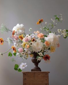 a vase filled with lots of different colored flowers