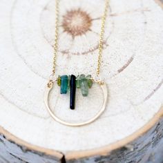 This necklace combines the beauty of abstract design with the ease and simplicity of a minimalist piece. A gorgeous row of natural green Tourmaline sticks in various lengths set into 14k Gold Filled chain and accented with a 14k Gold Filled semi-circle creating a modern pendant that’s easy to reach for daily. The rich olive tones that naturally occur in this beautiful gemstone give a botanical feel to this piece creating a beautiful balance among earthy, bohemian and modern. Modern Green Circular Jewelry, Green Minimalist Wire Wrapped Jewelry, Minimalist Green Wire Wrapped Jewelry, Metalsmith Jewelry, Earthy Bohemian, Bar Graph, Olive Tone, Necklace Bar, Jewellery Necklaces