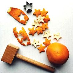 oranges, stars and hammer on a white surface with other items to make them look like they are made out of wood