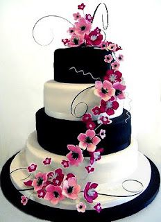 a three tiered wedding cake with white and blue flowers