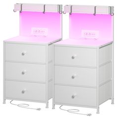 two white chests with pink lights on them