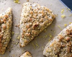 four pieces of chicken sitting on top of a piece of parchment paper covered in seasoning