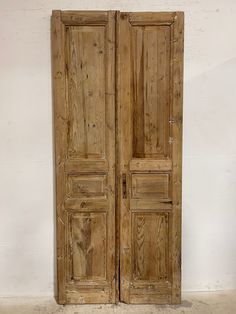 an old wooden double door in a room