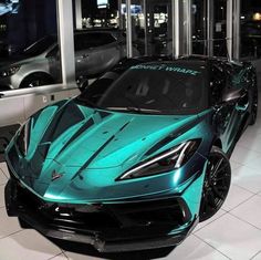 a blue and black sports car in a showroom