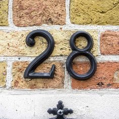 the number twenty two is shown in front of a brick wall with an iron cross