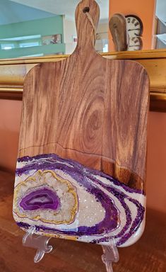 a wooden cutting board sitting on top of a table