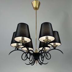 a chandelier with black shades hanging from the ceiling