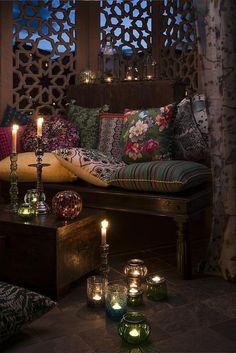 a living room with candles and pillows on the couch