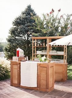 an outdoor bar is set up with drinks on it