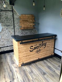 a wooden bar with the name smithy on it in front of a brick wall