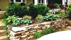 a rock wall with plants growing on it in front of a house and the words great rock landscaping tips