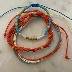 Set Of 3 Bracelets, Beaded Accents Orange And Blue With Green, Yellow, And White Accents 6.3-10 Inch Circumference Waterproof And Fade Proof! Handmade Orange Casual Friendship Bracelet, Casual Handmade Orange Friendship Bracelets, Casual Handmade Orange Friendship Bracelet, Casual Orange Braided Bracelets For Friendship, Casual Orange Braided Bracelet For Friendship, Adjustable Orange Friendship Bracelets With Colorful Beads, Adjustable Orange Beaded Bracelets, Bohemian Orange Friendship Bracelets For Vacation, Adjustable Orange Beaded Braided Bracelet