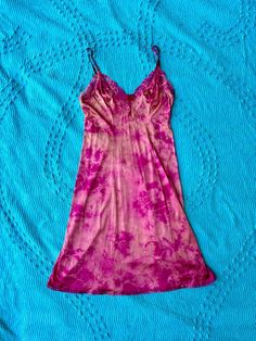 Expertly hand dyed nylon vintage slip dress. Layer this look over a turtle neck in the winter or over a swimsuit by the pool, they're great on their own too! This vintage slip has been carefully tie dyed to disguise stains and discoloration. Originally white, it has a unique all over tie dye pattern in bright pink. Can be washed on cold with like colors. This is a one of one item This slip is in very good vintage condition. There are no holes or tears. The straps are adjustable. Bust: 44" Waist: Fitted Pink Slip Dress For The Beach, Bohemian Fitted Dress For Loungewear, Fitted Bohemian Dresses For Loungewear, Vintage Pink Slip Dress For Summer, Vintage Fitted Slip Dress For Summer, Hand Dyed Fitted Summer Dress, Vintage Slip Dress, Dress Layer, Vintage Slip