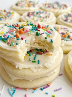 there are many cookies with white frosting and sprinkles