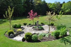 a garden with rocks and trees in the middle