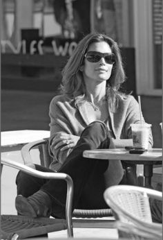 black and white photograph of woman sitting at table