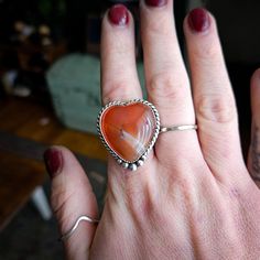 This funky carnelian heart is set in .925 sterling silver with hand forged sterling accents and will be finished in buyers size. The ring comes on a split sterling silver band. Please know your size and email or make note at checkout! All jewelry is handmade by Bree in Philadelphia, PA. Packaged with recycled products, all ready to ship items are processed in 3-5 days. Please allow a 10 day production period for all made to order pieces. Recycled Products, Philadelphia Pa, Sterling Silver Bands, Jewelry Lover, Hand Forged, Silver Band, Philadelphia, Period, Split