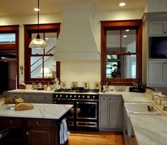 a large kitchen with an island in the middle and lots of windows on both sides