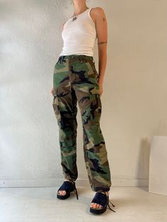 - Vintage authentic camouflage army pants  - Cotton nylon blend - Cinches at the waist - Button fly - Tagged XS Waist: 22" - 27"  Hip: 19.5" Rise: 11" Inseam: 30.5"   We are not responsible for lost, stolen, or damaged packages once they have been shipped. Any additional customs duties or taxes incurred on international orders are the responsibility of the buyer. Please note that our items are vintage and may have minor flaws or imperfections due to their age, which adds to their unique characte Camouflage Straight Leg Cargo Parachute Pants, Military Style High Waist Khaki Parachute Pants, Military Style High Waist Parachute Pants In Khaki, Camouflage Straight Leg Utility Cargo Pants, Camouflage Straight Leg Cargo Pants, Camouflage Full Length Utility Pants, Camouflage Full-length Utility Pants, Full Length Camouflage Utility Pants, Military Camouflage Straight Leg Pants