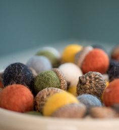 a bowl filled with lots of different colored balls