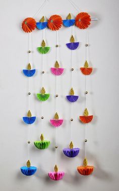 colorful paper fans are hanging on the wall