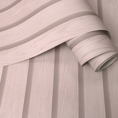 a close up of a wall covering with wood grains and white paper on it