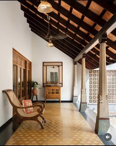 a large room with wooden ceiling and white walls