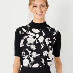 Style #599175 Embrace Easy Elegance With Our Mock Neck Sweater Tee, Styled With A Woven Floral Front. Mock Neck. Short Sleeves. Ribbed Neckline, Cuffs And Hem. Relaxed Fit 24 1/2" Long Available In: Black Fabric & Care Knit: 55% Cotton, 25% Modal, 20% Polyester; Woven: 100% Polyester Machine Washable Imported Brand New With Tags. Don't Forget To Bundle To Save On Shipping. Elegant Black Crew Neck Top, Floral Print Stretch Tops For Work, Elegant Short Sleeve Top With Floral Print, Stretch Floral Print Tops For Work, Elegant Short Sleeve Floral Print Top, Elegant Black Tops With Floral Print, Elegant Black Floral Print Tops, Fitted Black Floral Print Tops, Elegant Fitted Floral Print Tops